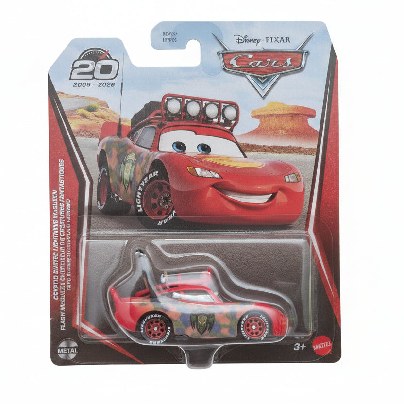 Disney Pixar Cars Lightning McQueen metal die-cast toy car in its original blister card packaging, featuring a red car with camouflage decals and a roof-mounted light bar.