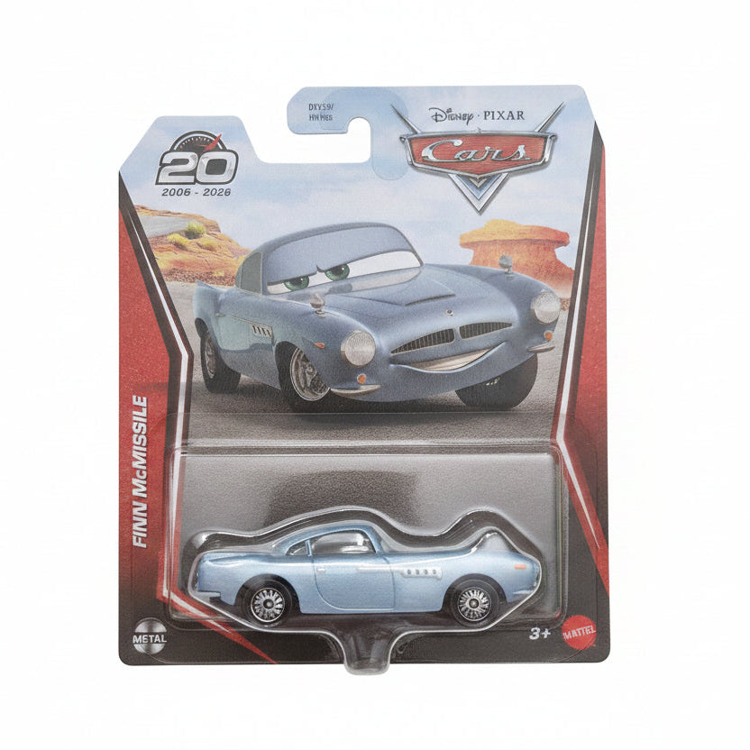 A packaged Disney Pixar Cars die-cast toy car, featuring Finn McMissile in a light blue sports car, on its original blister card packaging.